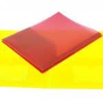 A closed red plastic folder, manufactured as part of stationery items in China, is placed on top of an open yellow plastic folder with two inner pockets.