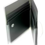 An open black expandable file folder, crafted for Manufacturing Stationery Items in China, features multiple empty pockets and a secure button closure, shown from an angled top view.