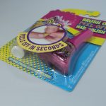 A packaged bottle of pink brush-on, peel-off nail polish labeled "Peels Off in Seconds," displayed on a white surface.