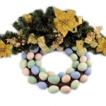 A decorative wreath made of pastel-colored eggs, green pine branches, and yellow flowers with gold accents.