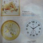 Catalog page showing three round wall clocks with nature-themed designs and one white wall clock with black numbers, each labeled with model numbers and sizes.