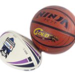 A rugby ball and a basketball are positioned side by side on a white background.