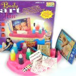Photo of a โBody Art Funโ kit with paints, stencils, glitter, a booklet, and a pink tray, designed for creating temporary body art for ages 6 and up.