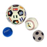 Four sports balls: a large soccer ball with international flags, a standard baseball, a small black-and-white soccer ball, and a small blue ball with white text.
