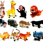 Twelve colorful plastic toy animals, including a kangaroo, giraffe, monkey, lion, hippos, camel, tiger, panther, elephant, and others, arranged in rows on a white background.