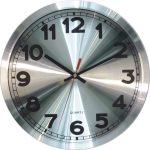 A round silver wall clock with black numbers, black hour and minute hands, and a red second hand, showing the time as 10:10:06.