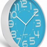 A round wall clock with a blue face, white frame, and white numbers and hands showing the time as 10:35:34.