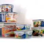 A set of plastic food storage containers with snap-on lids in various sizes, labeled with volumes and images of food.