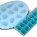 Two empty blue ice cube trays, one oval-shaped with round molds and one rectangular with square molds, are placed side by side on a white background.