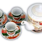 A ceramic coffee set with three cups on saucers and a teapot, all decorated with coffee-themed designs and images of coffee beans.