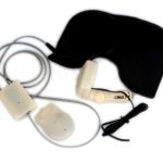A black sleep mask attached to electronic components with wires, including a control unit and a sensor device.