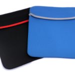 Two soft laptop sleeves are shown: one is black with a red trim, and the other is blue with a gray trim, both lying flat and partially overlapping.