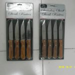 Two packs of stainless steel steak knives with brown handles, each containing four knives, placed on a tiled surface.