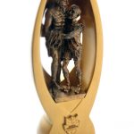 A bronze-colored trophy featuring two soccer players inside a stylized oval frame, with a small plaque at the base.