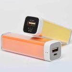 Two rectangular portable power banks, one orange and one yellow, each with USB and micro-USB ports for charging devices, are shown on a white background.