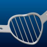 A digital illustration of a metallic, heart-shaped grill plate with two mounting tabs on either side, set against a blue gradient background.